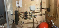 a room with a hot water tank and pipes
