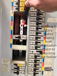 a person is using a screwdriver to open a circuit breaker