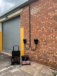 an electric car charging station in front of a brick building