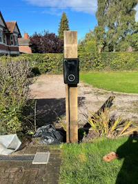 a parking meter on a pole in front of a house