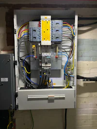 an electrical panel with wires attached to it